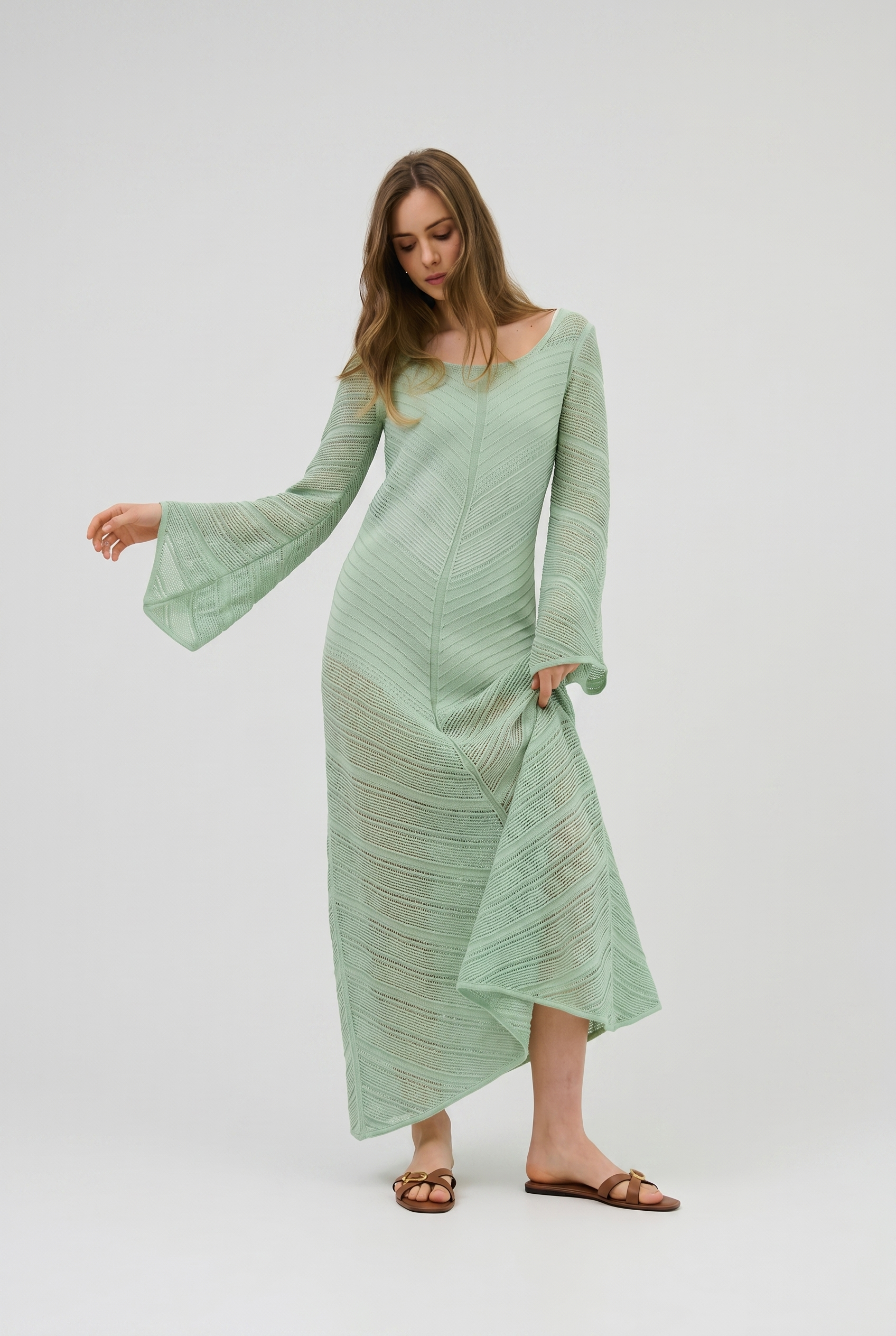 Model wearing pistachio openwork cotton maxi dress with flared sleeves